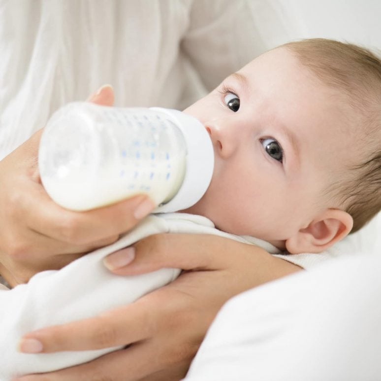 A mother feeding her baby with milk