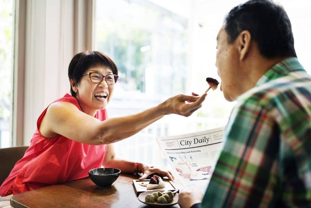 A woman feeding her husband