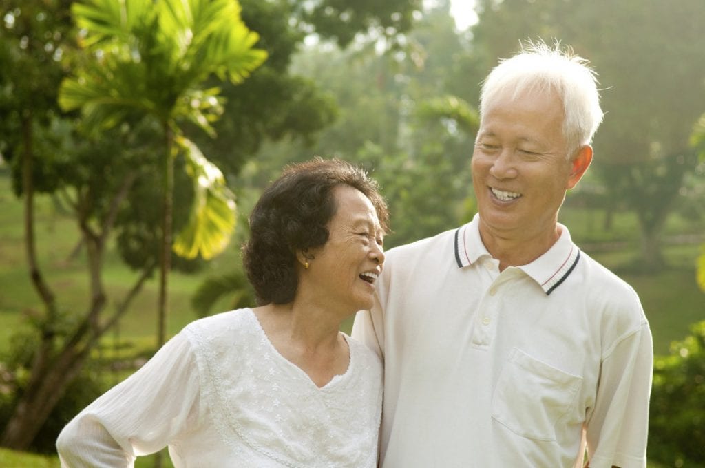 Asian Senior Couple having a conversation at an outdoor park