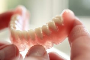 holding a denture